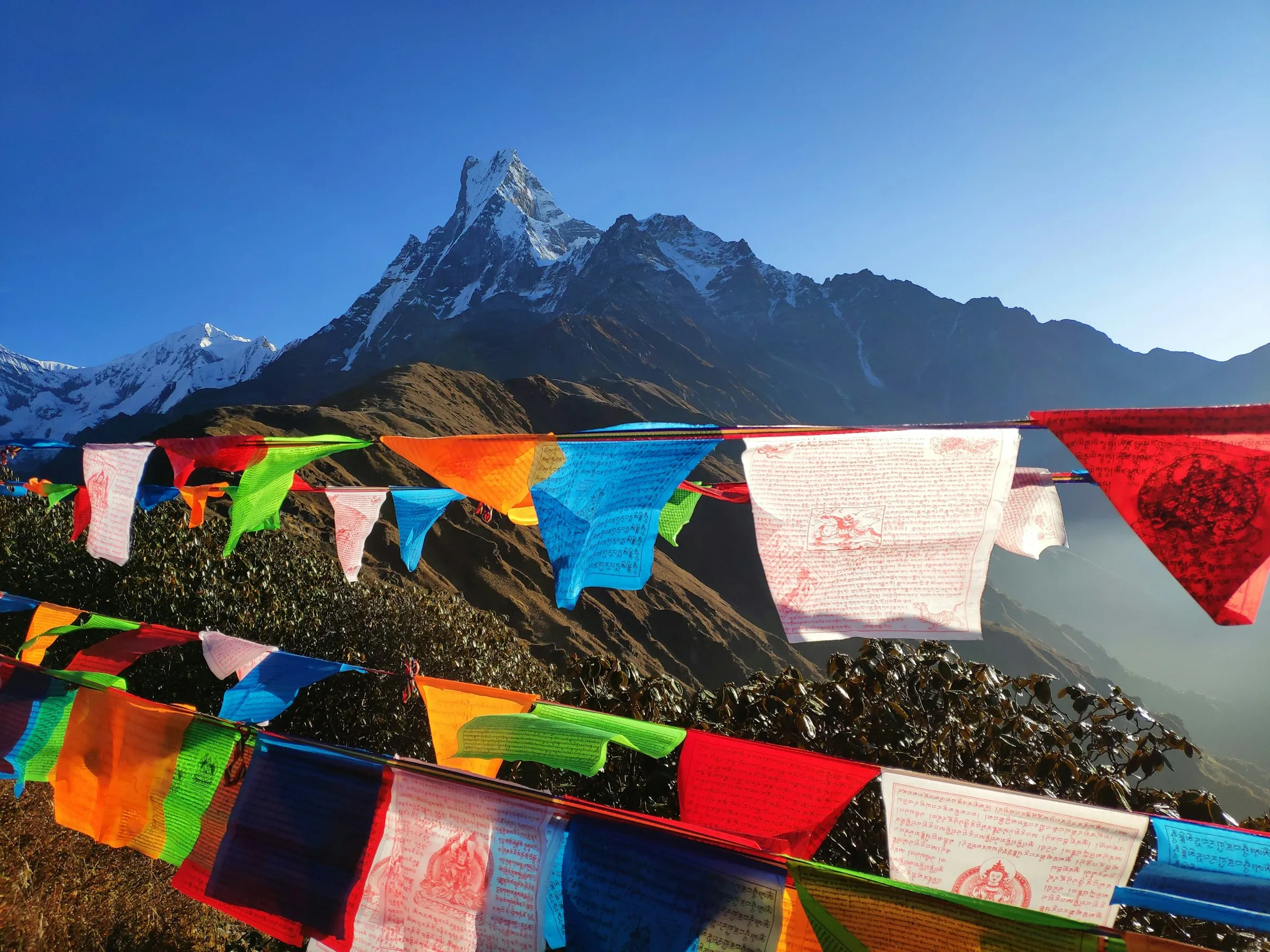 Machapuchare (Fishtail) behind prayer flags at Mardi Himal Base Camp